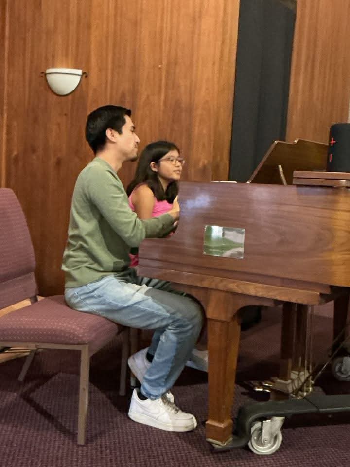 Child taking a piano lesson at the Norwalk Life Transformation Center