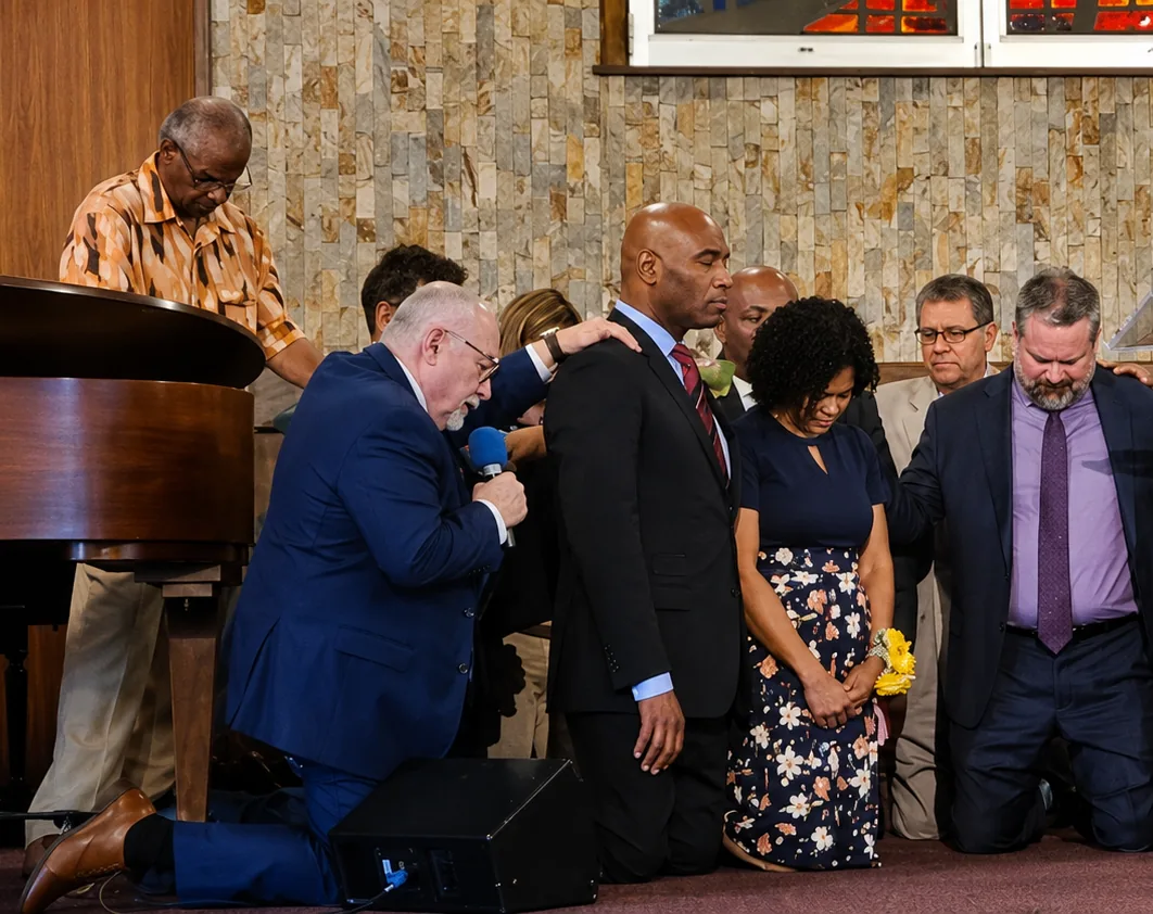 Church leaders praying with laying on of hands